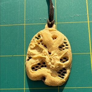 Intricate Cream Dragon Pendant for Reptile Enthusiasts